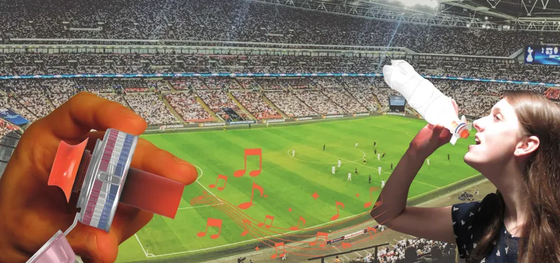 Dopfluit whistle cap held up in a football stadium